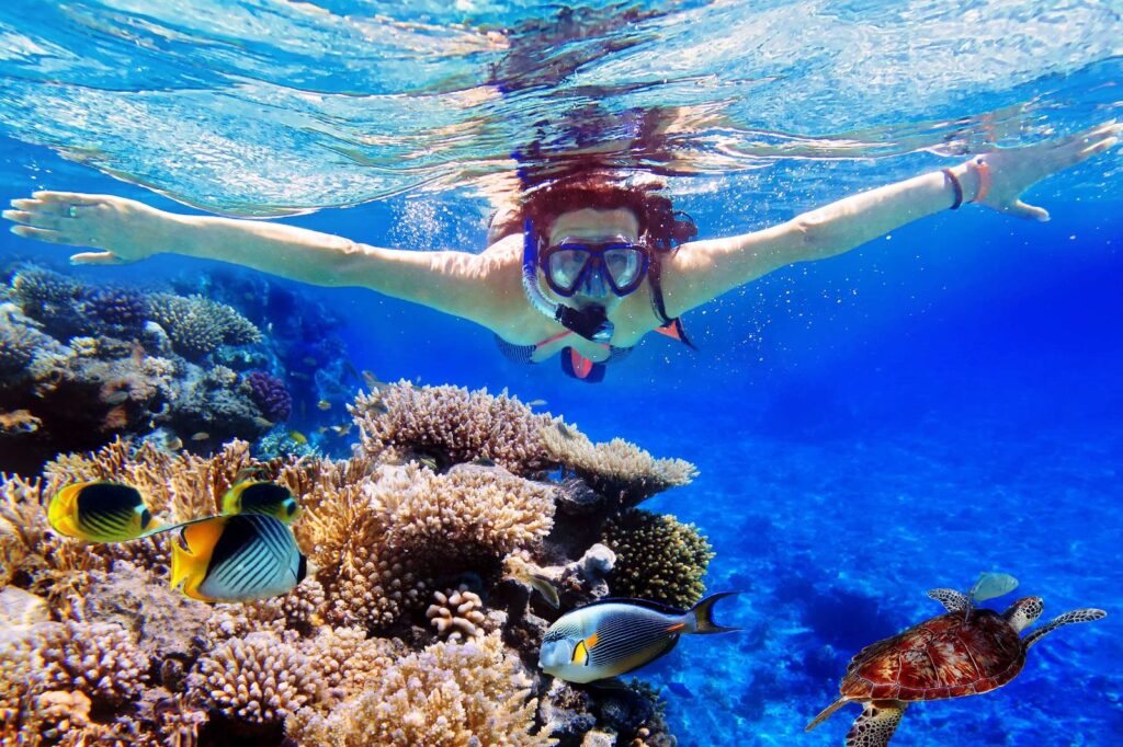 Young women at snorkeling in the tropical water