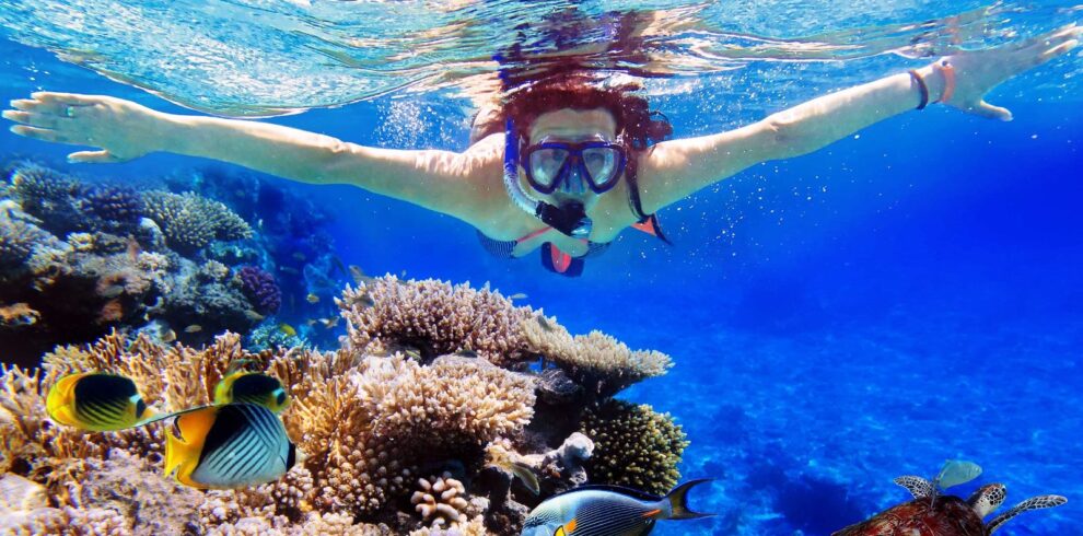 Young women at snorkeling in the tropical water