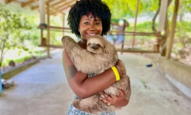 girl holding sloth