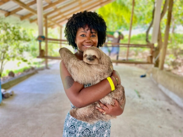 girl holding sloth